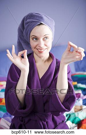 Playful woman in bathrobe flossing teeth View Large Photo Image Stock Image - Playful woman in bathrobe flossing teeth. Fotosearch