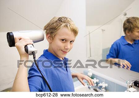 Portrait of boy blow-drying hair View Large Photo Image Stock Photo - Portrait of boy blow-drying hair. Fotosearch