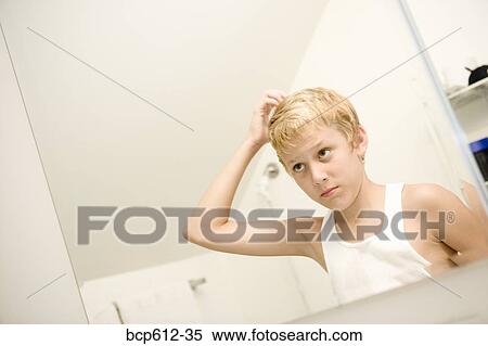 Portrait of boy styling hair View Large Photo Image Stock Photography - Portrait of boy styling hair. Fotosearch