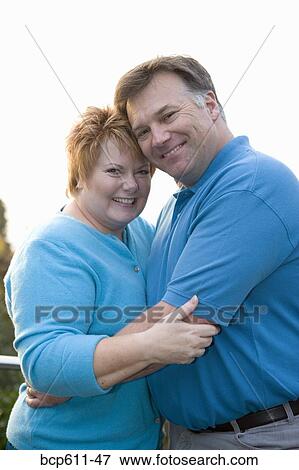 Portrait of middle aged couple hugging View Large Photo Image Stock Photo - Portrait of middle aged couple hugging. Fotosearch