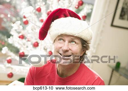 Portrait of playful man at Christmastime View Large Photo Image Stock Image - Portrait of playful man at Christmastime. Fotosearch