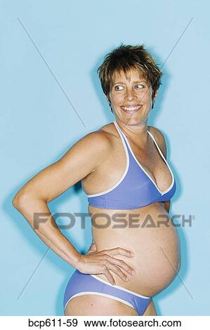 Stock Photo - Portrait of pregnant woman in bikini. Fotosearch