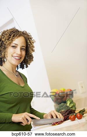 Portrait of woman chopping vegetables View Large Photo Image Stock Photo - Portrait of woman chopping vegetables. Fotosearch