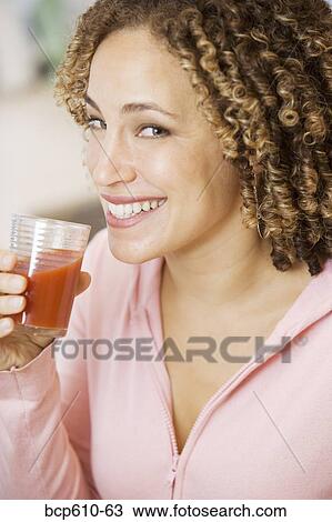 Portrait of woman drinking tomato juice View Large Photo Image Stock Image - Portrait of woman drinking tomato juice. Fotosearch