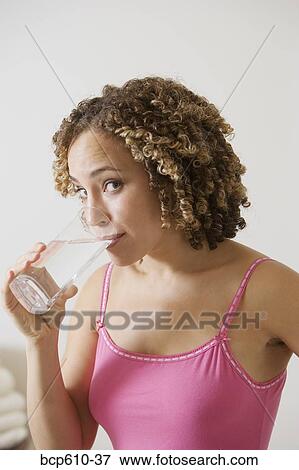 Portrait of woman drinking water View Large Photo Image Stock Photo - Portrait of woman drinking water. Fotosearch