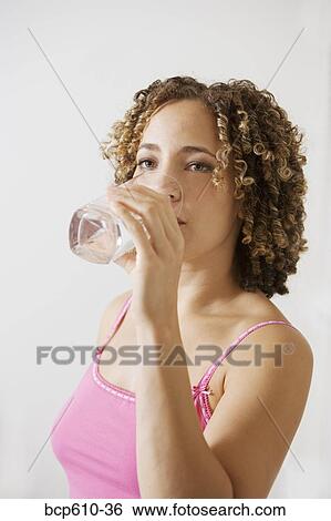 Portrait of woman drinking water View Large Photo Image Stock Photograph - Portrait of woman drinking water. Fotosearch