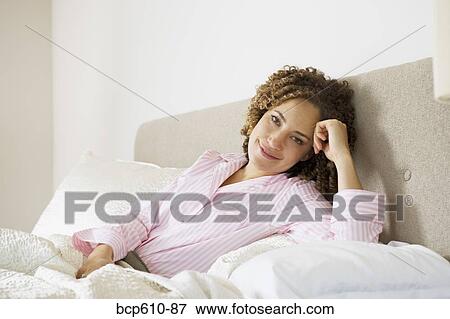 Portrait of woman in pajamas in bed View Large Photo Image Stock Photo - Portrait of woman in pajamas in bed. Fotosearch