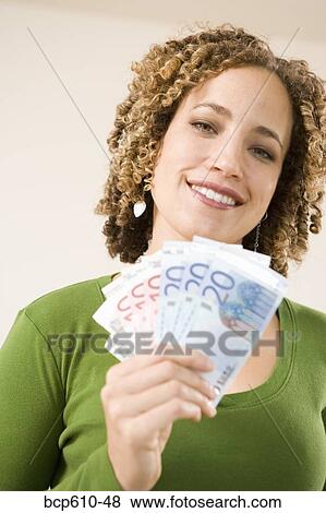 Portrait of woman with handful of Euros View Large Photo Image Stock Photo - Portrait of woman with handful of Euros. Fotosearch