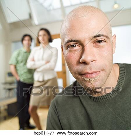 Stock Photo - Portrait of young man with shaved head. Fotosearch
