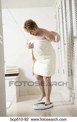 Shocked overweight woman on bathroom scale View Large Photo Image Stock Image - Shocked overweight woman on bathroom scale. Fotosearch
