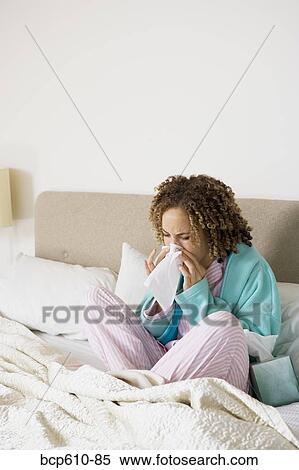 Sick woman in bed blowing nose View Large Photo Image Stock Photography - Sick woman in bed blowing nose. Fotosearch