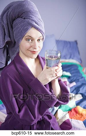 Smiling woman in bathrobe with water View Large Photo Image Stock Photography - Smiling woman in bathrobe with water. Fotosearch
