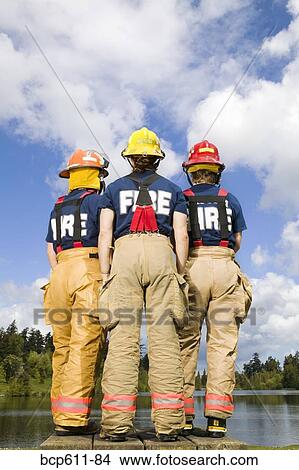 Three female firefighters viewed from behind View Large Photo Image Picture - Three female firefighters viewed from behind. Fotosearch
