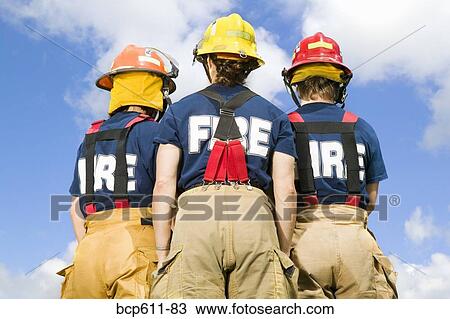 Three female firefighters viewed from behind View Large Photo Image Stock Image - Three female firefighters viewed from behind. Fotosearch