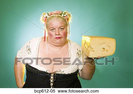 Uninterested Germanic woman with cheese wedge View Large Photo Image Stock Photography - Uninterested Germanic woman with cheese wedge. Fotosearch