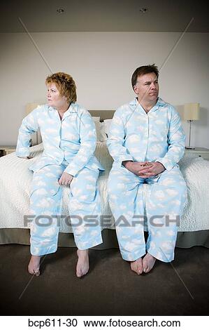 Upset couple in matching pajamas View Large Photo Image Stock Image - Upset couple in matching pajamas. Fotosearch