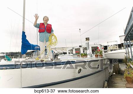 Waving woman on deck of houseboat View Large Photo Image Stock Photo - Waving woman on deck of houseboat. Fotosearch
