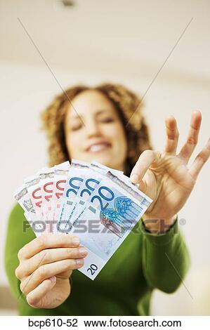 Woman choosing bill from handful of Euros View Large Photo Image Stock Image - Woman choosing bill from handful of Euros. Fotosearch