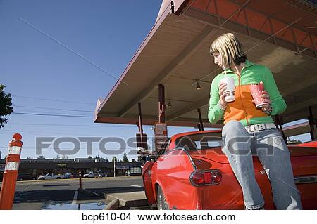 Woman eating at drive-in restaurant View Large Photo Image Picture - Woman eating at drive-in restaurant. Fotosearch