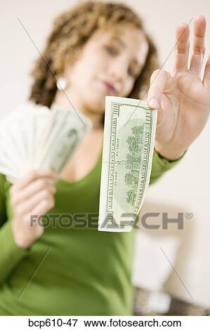 Woman holding a hundred dollar bill View Large Photo Image Stock Photo - Woman holding a hundred dollar bill. Fotosearch