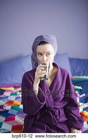 Woman in bathrobe drinking water View Large Photo Image Stock Image - Woman in bathrobe drinking water. Fotosearch