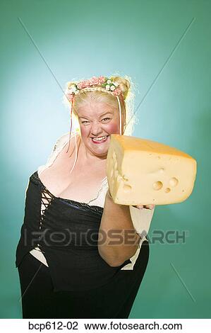 Woman in Germanic costume with cheese wedge View Large Photo Image Stock Image - Woman in Germanic costume with cheese wedge. Fotosearch
