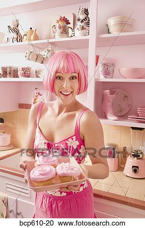 Woman in kitchen with pink hair and cupcakes View Large Photo Image Stock Image - Woman in kitchen with pink hair and cupcakes. Fotosearch