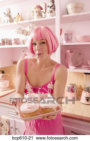 Woman in kitchen with pink hair and cupcakes View Large Photo Image Stock Image - Woman in kitchen with pink hair and cupcakes. Fotosearch