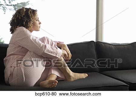 Woman in pajamas looking out window View Large Photo Image Stock Image - Woman in pajamas looking out window. Fotosearch