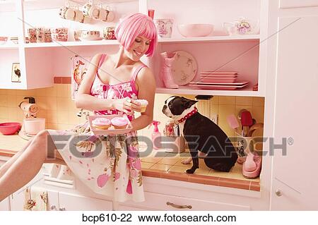 Woman in retro kitchen with dog and cupcakes View Large Photo Image Stock Image - Woman in retro kitchen with dog and cupcakes. Fotosearch
