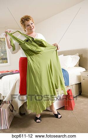 Woman looking at purchases after shopping View Large Photo Image Stock Image - Woman looking at purchases after shopping. Fotosearch