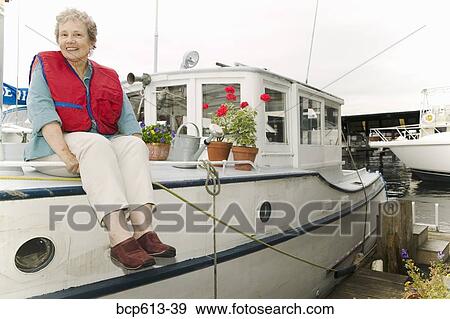Woman on houseboat with plants View Large Photo Image Stock Photo - Woman on houseboat with plants. Fotosearch