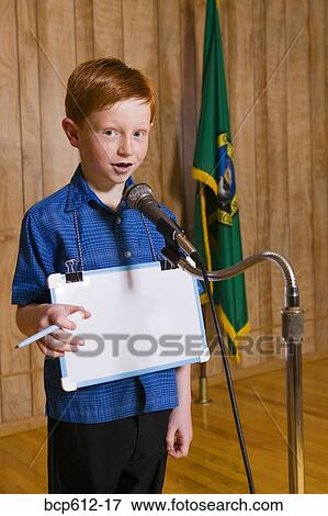 Young boy speaking at microphone View Large Photo Image Stock Photo - Young boy speaking at microphone. Fotosearch