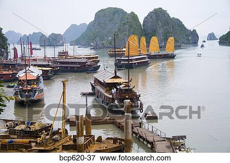 Boats and rocky islands in Vietnamese harbor View Large Photo Image Stock Photo - Boats and rocky islands in Vietnamese harbor. Fotosearch
