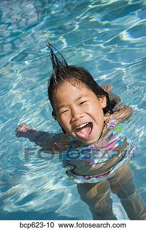 Closeup of girl in pool with silly hairdo View Large Photo Image Stock Image - Closeup of girl in pool with silly hairdo. Fotosearch