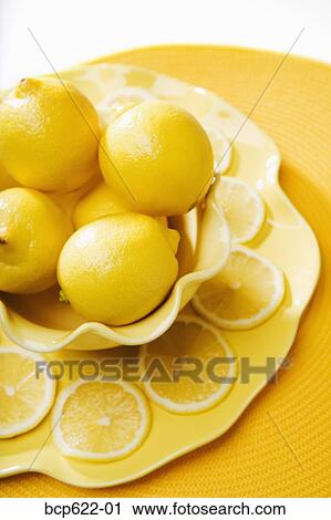 Closeup of lemons and lemon slices View Large Photo Image Stock Image - Closeup of lemons and lemon slices. Fotosearch