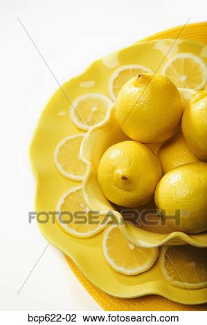 Closeup of lemons and lemon slices View Large Photo Image Stock Image - Closeup of lemons and lemon slices. Fotosearch