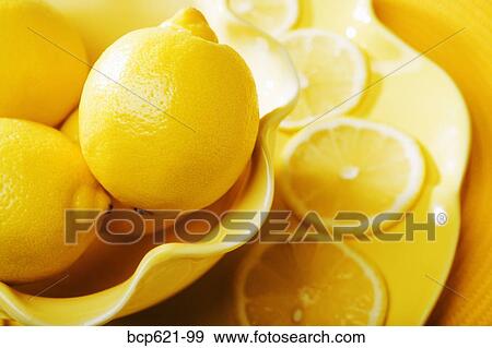 Closeup of lemons and lemon slices View Large Photo Image Stock Photo - Closeup of lemons and lemon slices. Fotosearch