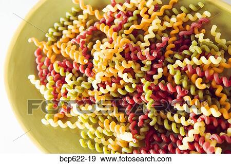 Closeup of multicolored curly dry pasta View Large Photo Image Stock Photo - Closeup of multicolored curly dry pasta. Fotosearch