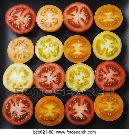 Closeup of multicolored tomato slices View Large Photo Image Stock Photo - Closeup of multicolored tomato slices. Fotosearch