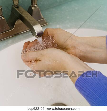 Closeup of washing hands in bathroom sink View Large Photo Image Picture - Closeup of washing hands in bathroom sink. Fotosearch