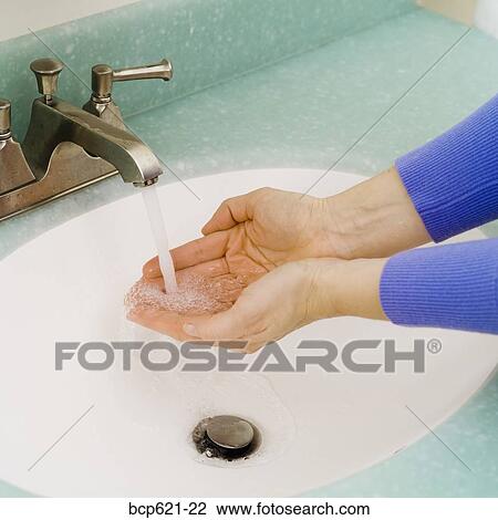 Closeup of washing hands in bathroom sink View Large Photo Image Stock Image - Closeup of washing hands in bathroom sink. Fotosearch