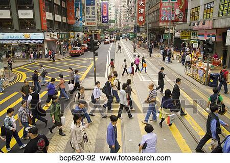 Stock Image - Crowded crosswalk on Hong Kong street. Fotosearch