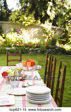 Stock Photography - Dishes on table in garden. Fotosearch
