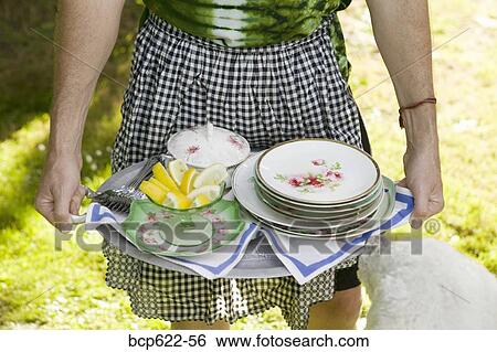 Dog sniffing serving tray held by man in apron View Large Photo Image Stock Photograph - Dog sniffing serving tray held by man in apron. Fotosearch