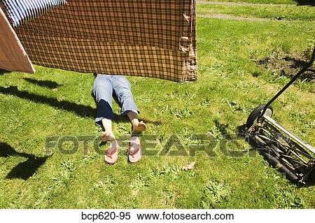 Drying laundry and woman lying in grass View Large Photo Image Stock Photography - Drying laundry and woman lying in grass. Fotosearch