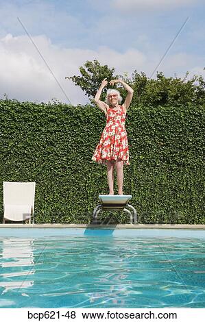 Elderly woman dancing on diving board View Large Photo Image Stock Photo - Elderly woman dancing on diving board. Fotosearch