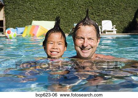 Father and daughter with mohawks in pool View Large Photo Image Stock Photograph - Father and daughter with mohawks in pool. Fotosearch