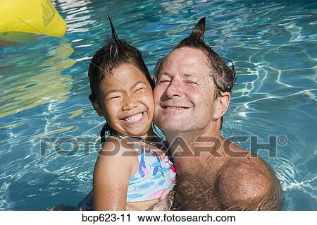 Father and daughter with silly hairdos in pool View Large Photo Image Stock Image - Father and daughter with silly hairdos in pool. Fotosearch