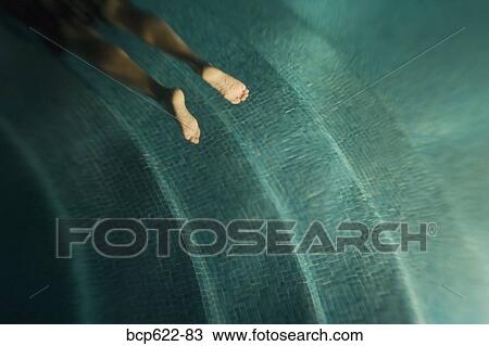 Feet of man swimming underwater View Large Photo Image Stock Image - Feet of man swimming underwater. Fotosearch